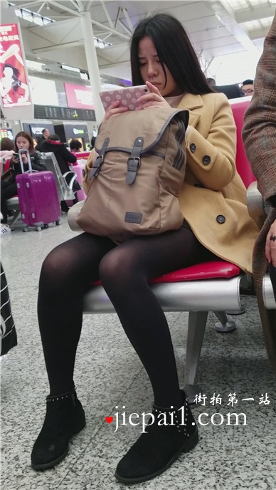 4k-高铁站候车室拍摄低头玩手机的黑丝美腿女孩。